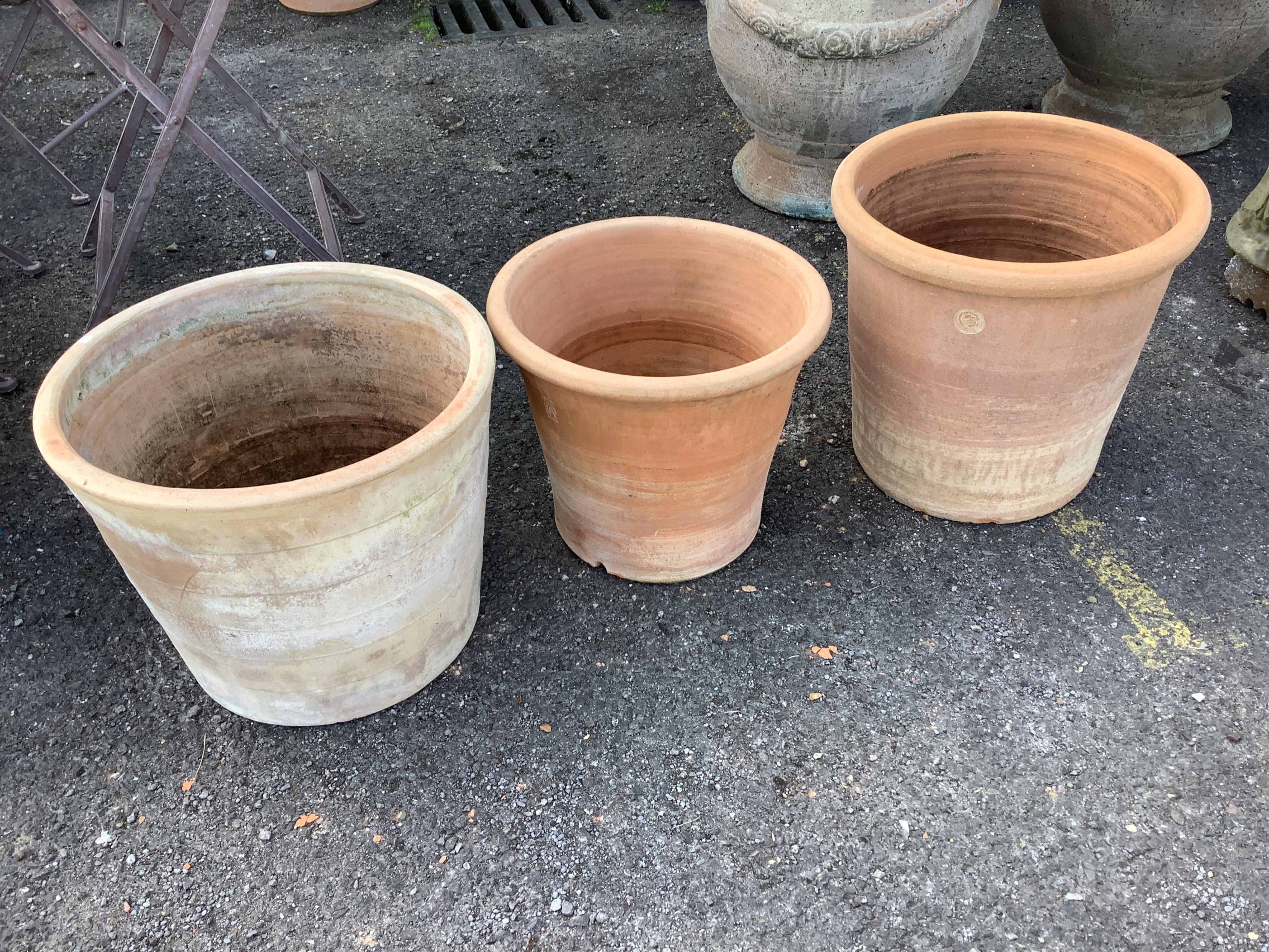 Three circular terracotta garden planters, largest diameter 44cm, height 35cm